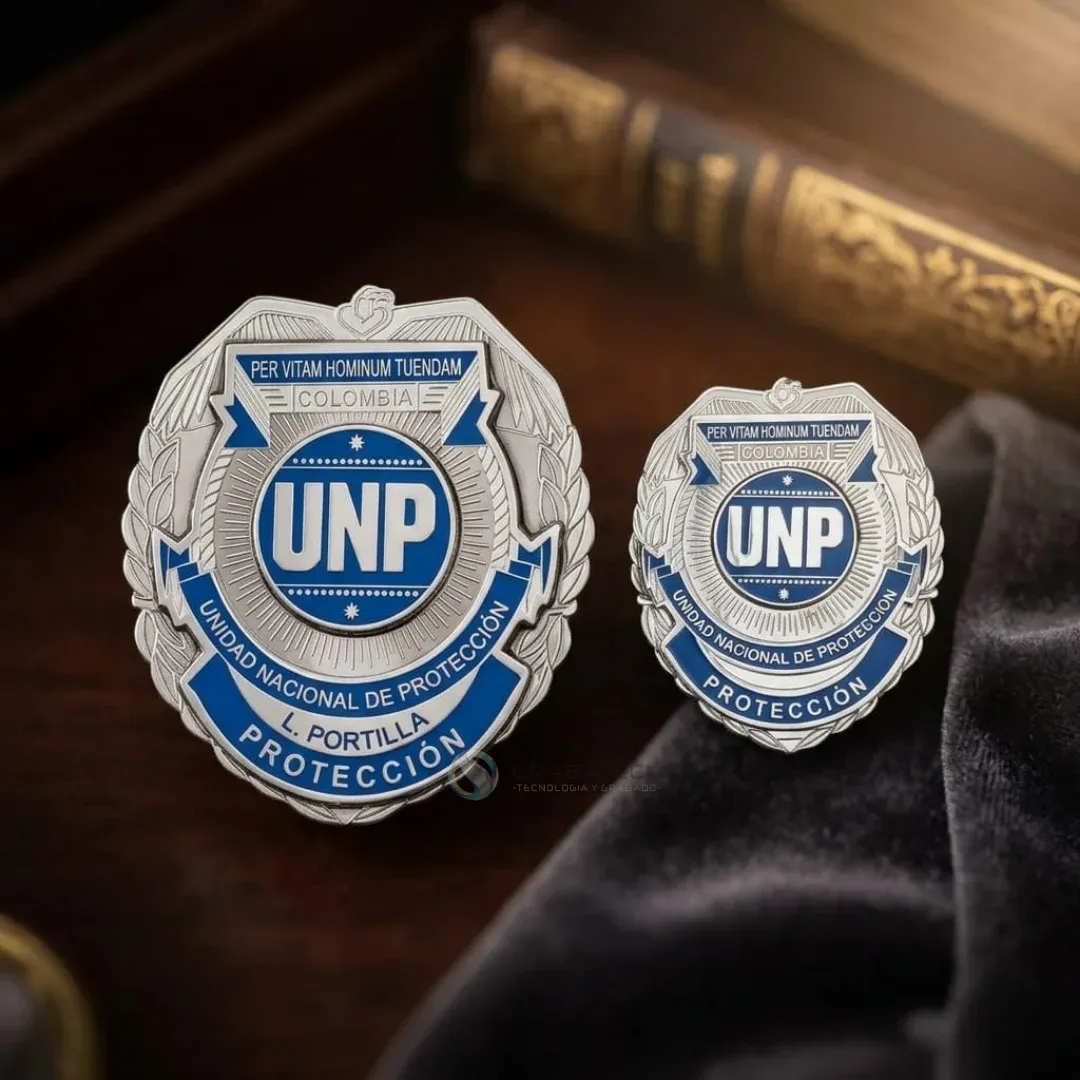 Dos placas metálicas de protección con escudo azul y plateado sobre terciopelo negro